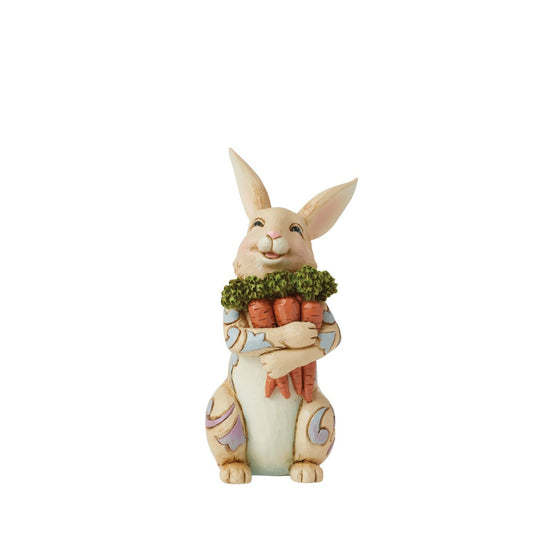 With an arm full of carrots, this cheerful Pint bunny is ready for Easter| Colourful blue and purple rosemaling on his fur, this fluffy Jim Shore rabbit figurine is a delightful edition to your Springtime home décor.