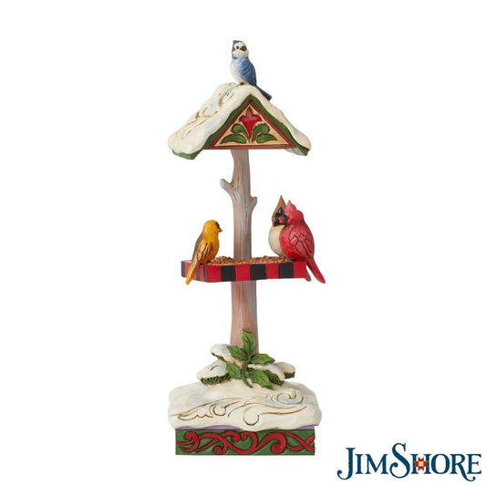 Jim Shore Heartwood Creek Christmas Bird Feeder  Bird watching is always enjoyable, but even more so in wintertime when their vibrant colours contrast against the snow. This inviting Jim Shore piece puts a flock of birds together for the holidays. Tweeting together at a feeder, holly grows nearby.