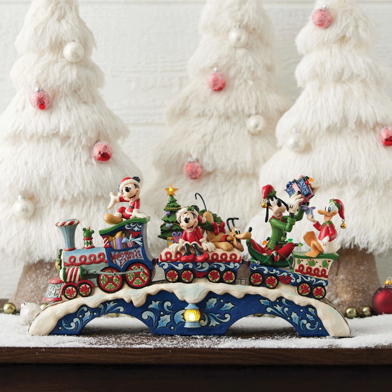 This fantastic Jim Shore Mickey Mouse Express chugs along a snowy track, bringing festive cheer as it lights up and plays eight beloved Christmas tunes. With intricate details, the train showcases Mickey and his friends, trees, gifts, and lights.