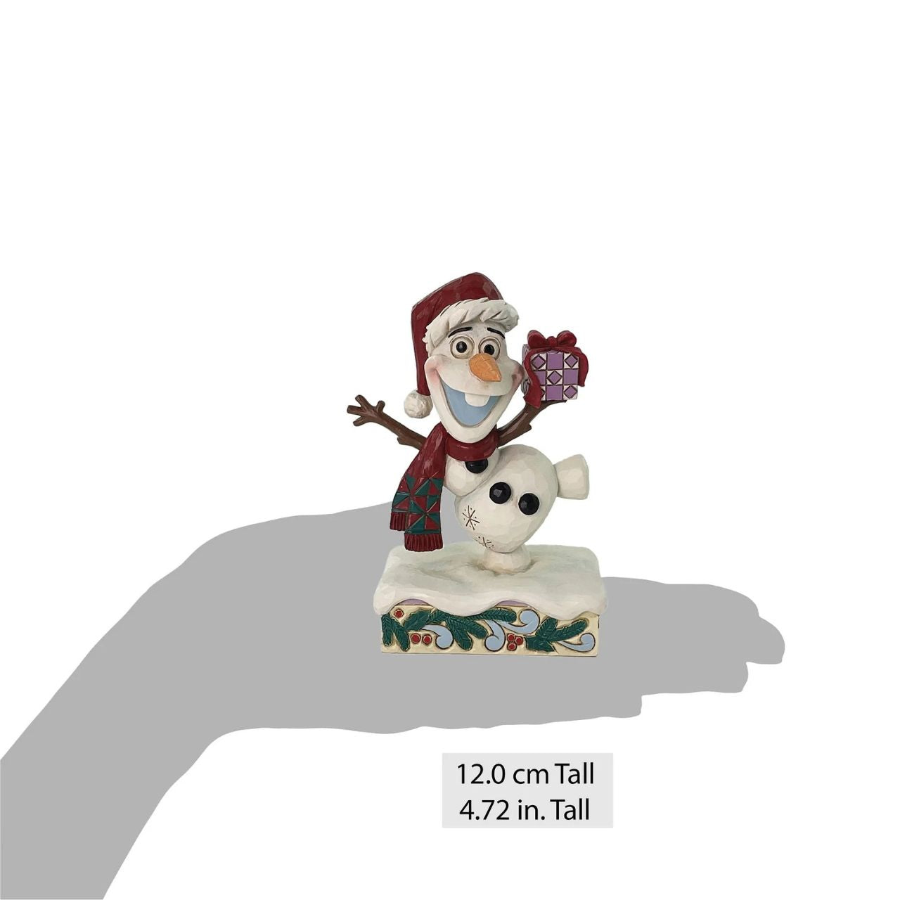 In this joyful Jim Shore design, Olaf dances merrily in the snow with a wide smile, donning a Santa hat and a festive scarf while carrying a colourful present. Adorned with charming rosemaling details, this delightful piece captures holiday cheer.