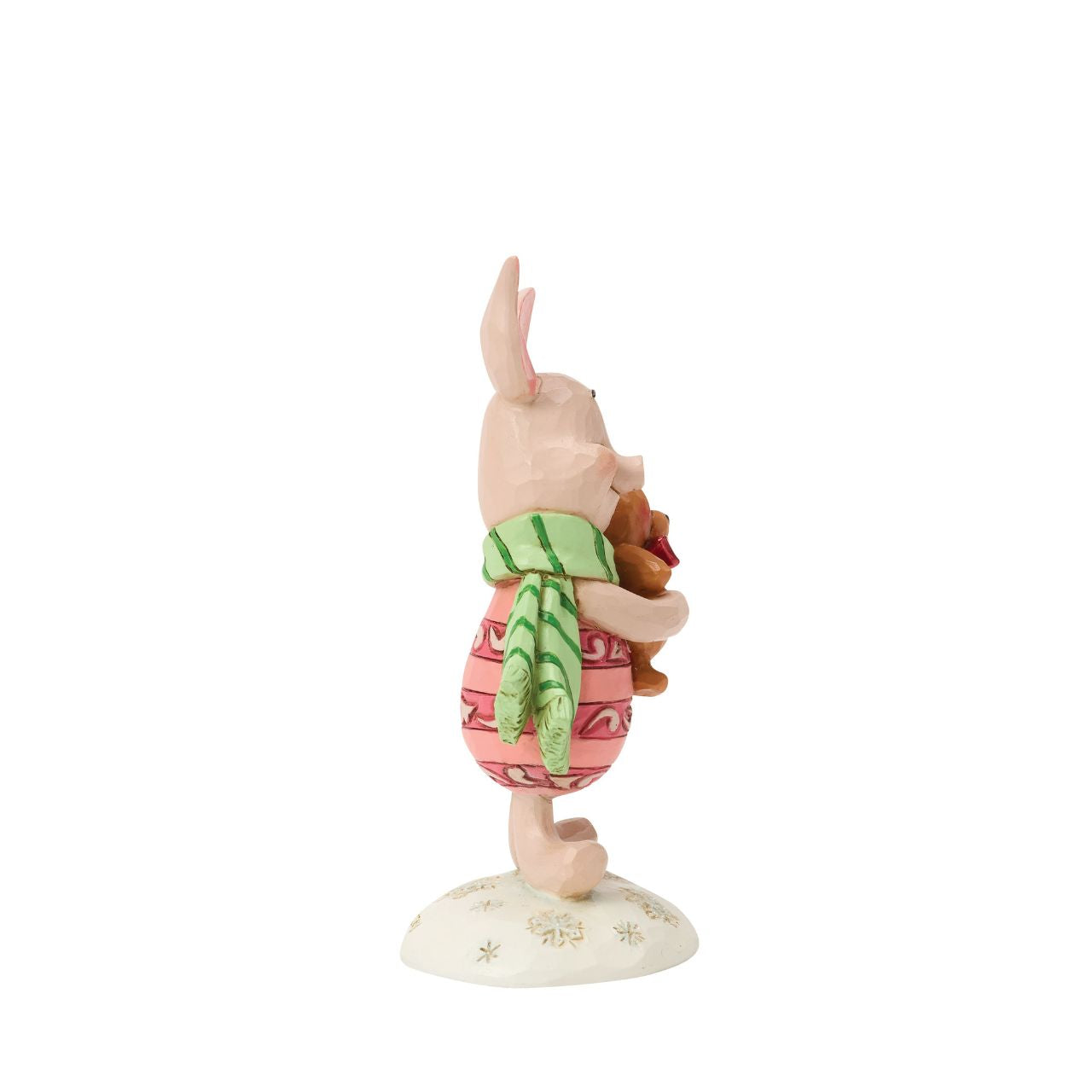 Piglet shines with holiday sweetness in this petite Jim Shore holiday design. Dressed for the season in a cosy scarf, Piglet is brimming with charm, as they hug a stuffed bear with the gentle joy of the Hundred Acre Wood in collectible size.