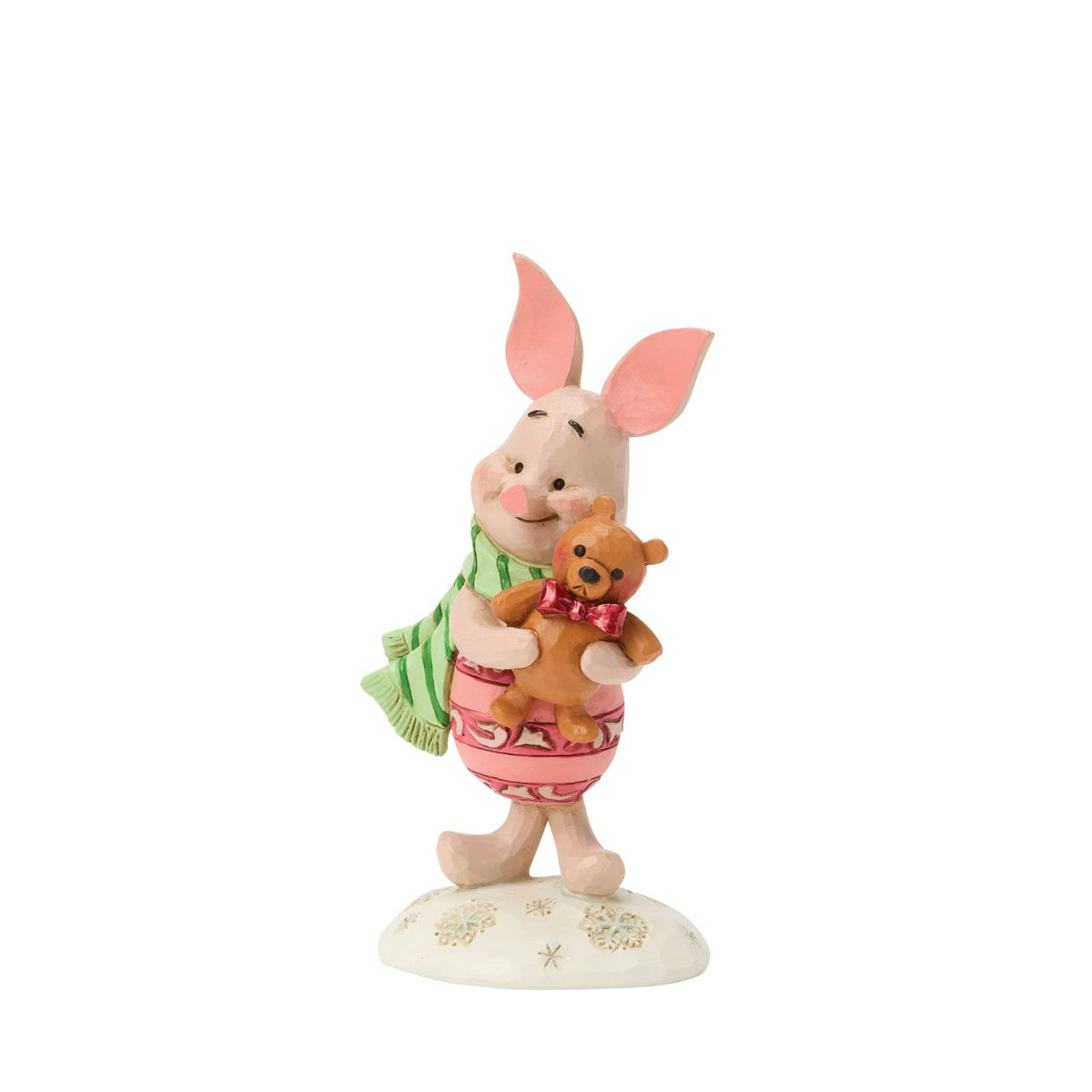 Piglet shines with holiday sweetness in this petite Jim Shore holiday design. Dressed for the season in a cosy scarf, Piglet is brimming with charm, as they hug a stuffed bear with the gentle joy of the Hundred Acre Wood in collectible size.