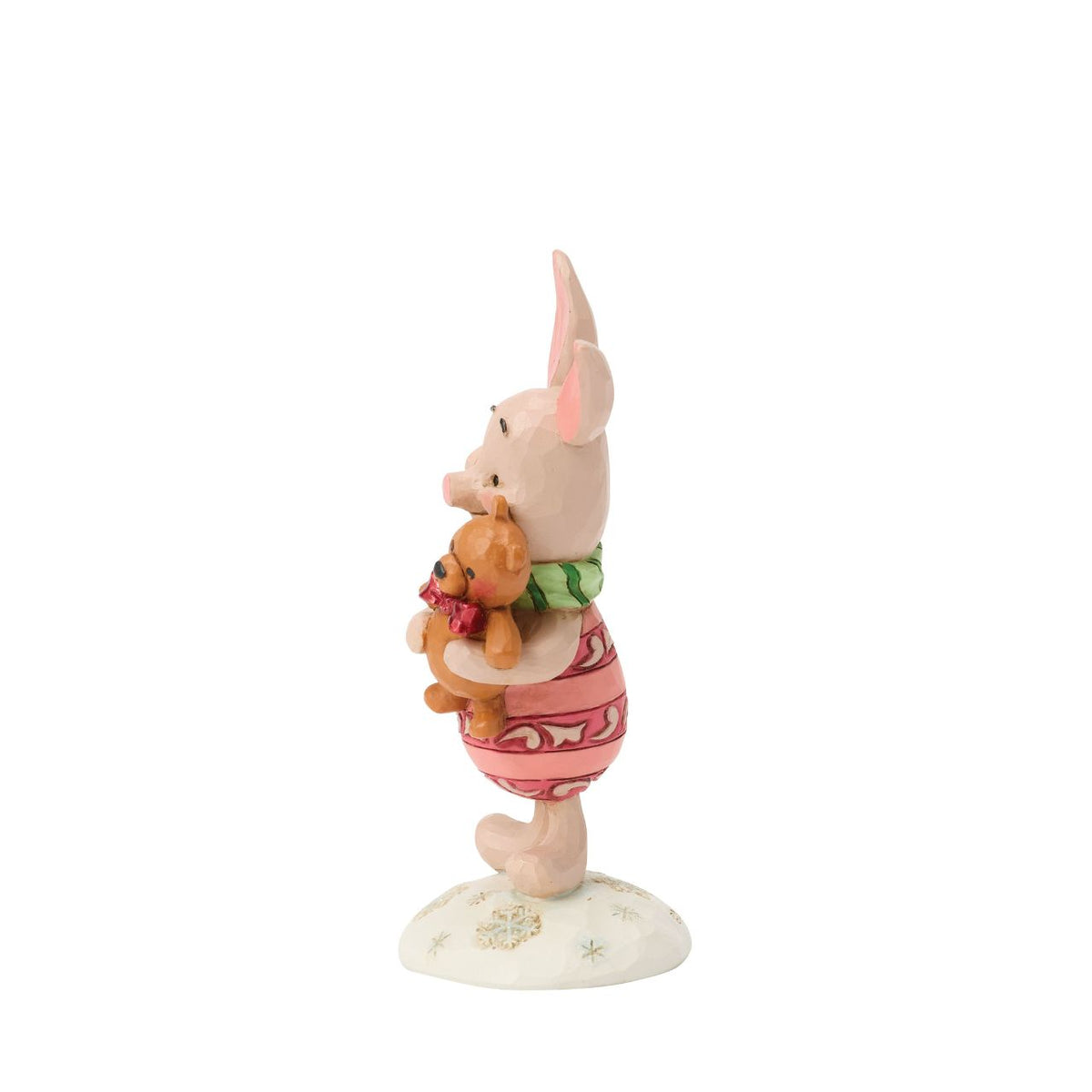 Piglet shines with holiday sweetness in this petite Jim Shore holiday design. Dressed for the season in a cosy scarf, Piglet is brimming with charm, as they hug a stuffed bear with the gentle joy of the Hundred Acre Wood in collectible size.
