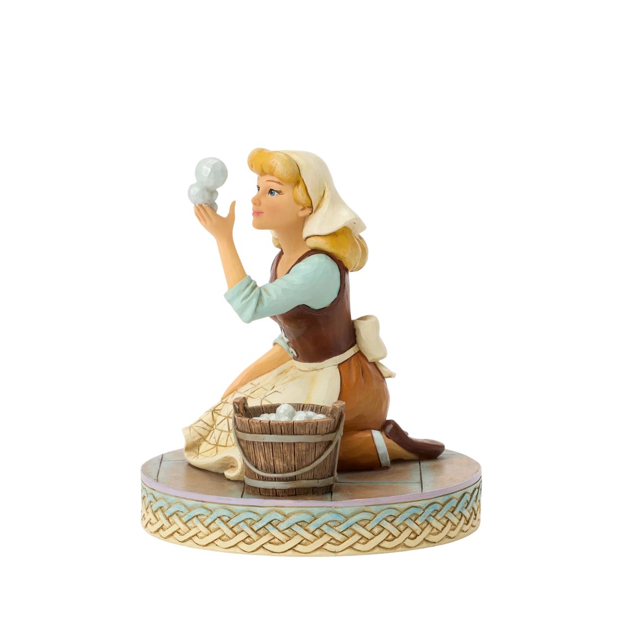 Cinderella's spirit remains unbroken in this inspiring Jim Shore scene. Dressed as a maid, she finds joy in her work, catching a bubble as she scrubs the floors. Jim Shore's enchanting details capture her beauty and resilience.