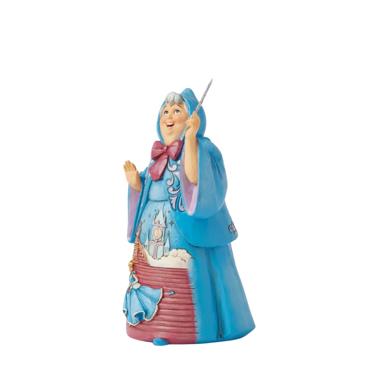 In this magical Jim Shore design, the Fairy Godmother smiles with her wand, her rosemaling blue robes parting to reveal Cinderella racing down the steps as the clock strikes midnight. This captivating moment is when she will lose her glass slipper.