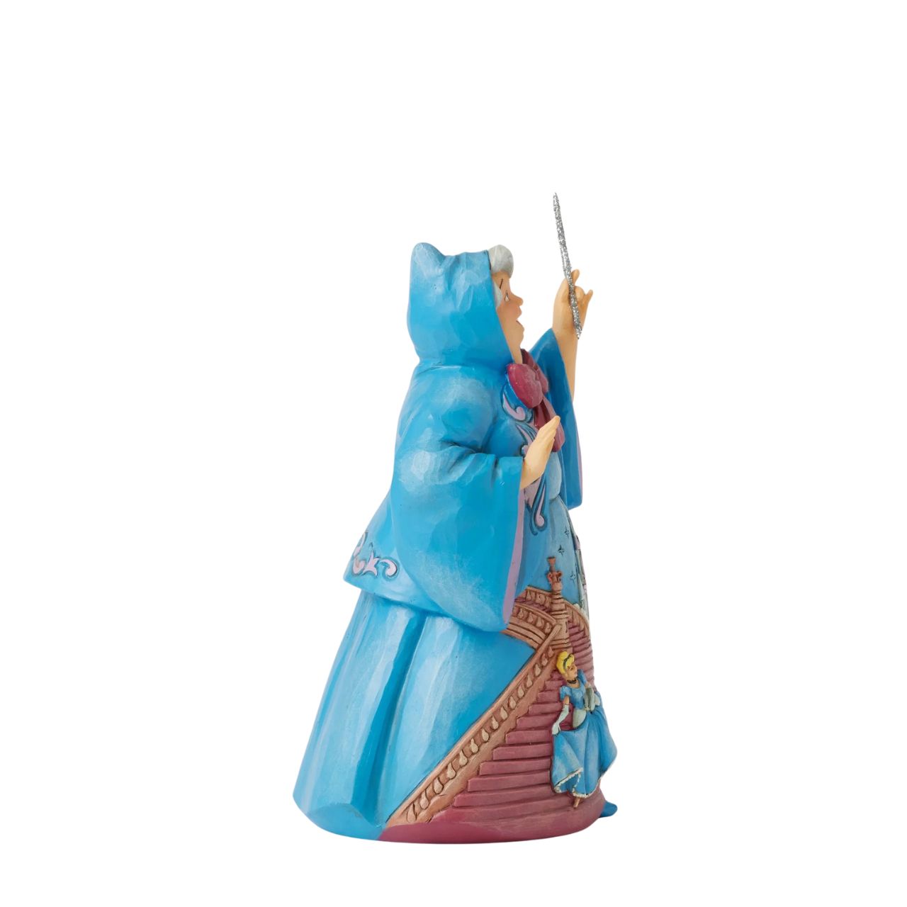 In this magical Jim Shore design, the Fairy Godmother smiles with her wand, her rosemaling blue robes parting to reveal Cinderella racing down the steps as the clock strikes midnight. This captivating moment is when she will lose her glass slipper.