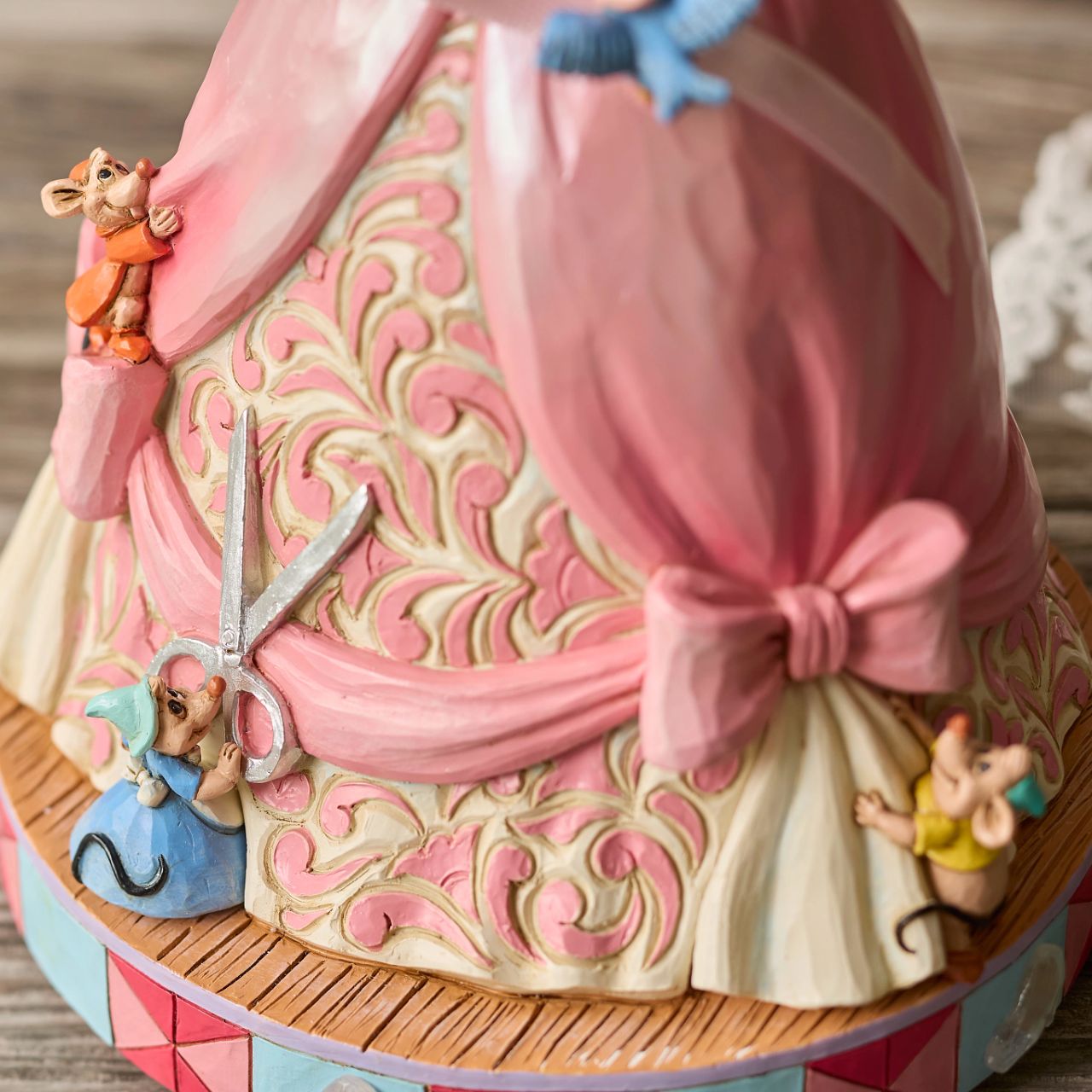 The iconic pink dress from Disney's 1950 masterpiece Cinderella, has been reimagined by artist Jim Shore. With Cinderellas bird and mouse friends, this beautiful dress comes to life. To make this figurine even more special, it plays A Dream is a Wish Your Heart Makes from the film.