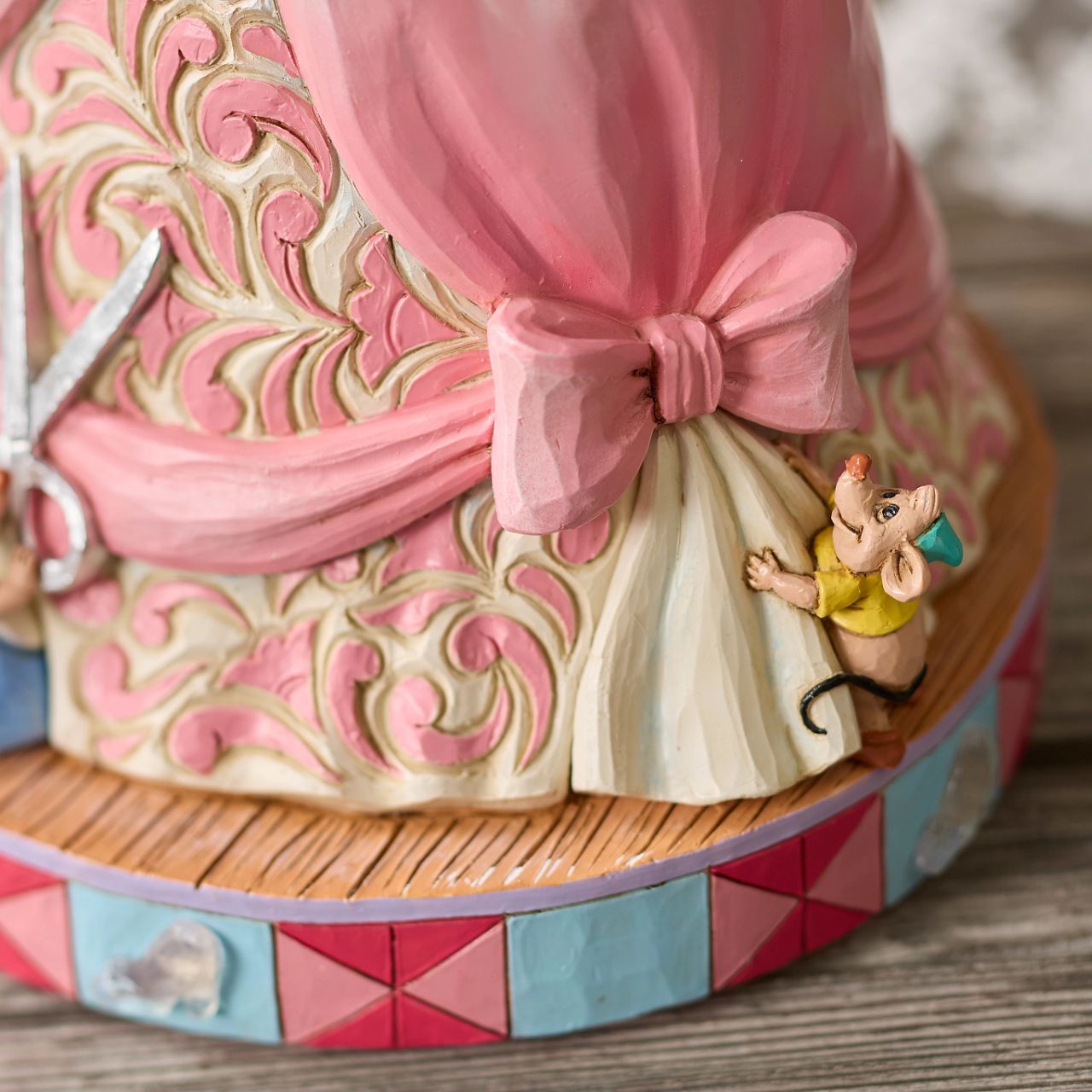 The iconic pink dress from Disney's 1950 masterpiece Cinderella, has been reimagined by artist Jim Shore. With Cinderellas bird and mouse friends, this beautiful dress comes to life. To make this figurine even more special, it plays A Dream is a Wish Your Heart Makes from the film.