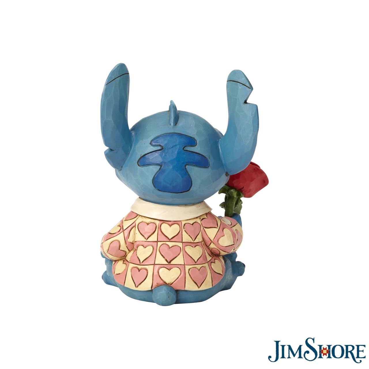 Jim Shore Clueless Casanova Stitch Figurine  Stitch has transformed into a model citizen that Lilo would be proud of! Designed by Jim Shore, the adorable alien wears a heart-patterned shirt as he offers a single red rose. Stitch makes a great gift for your Ohana.