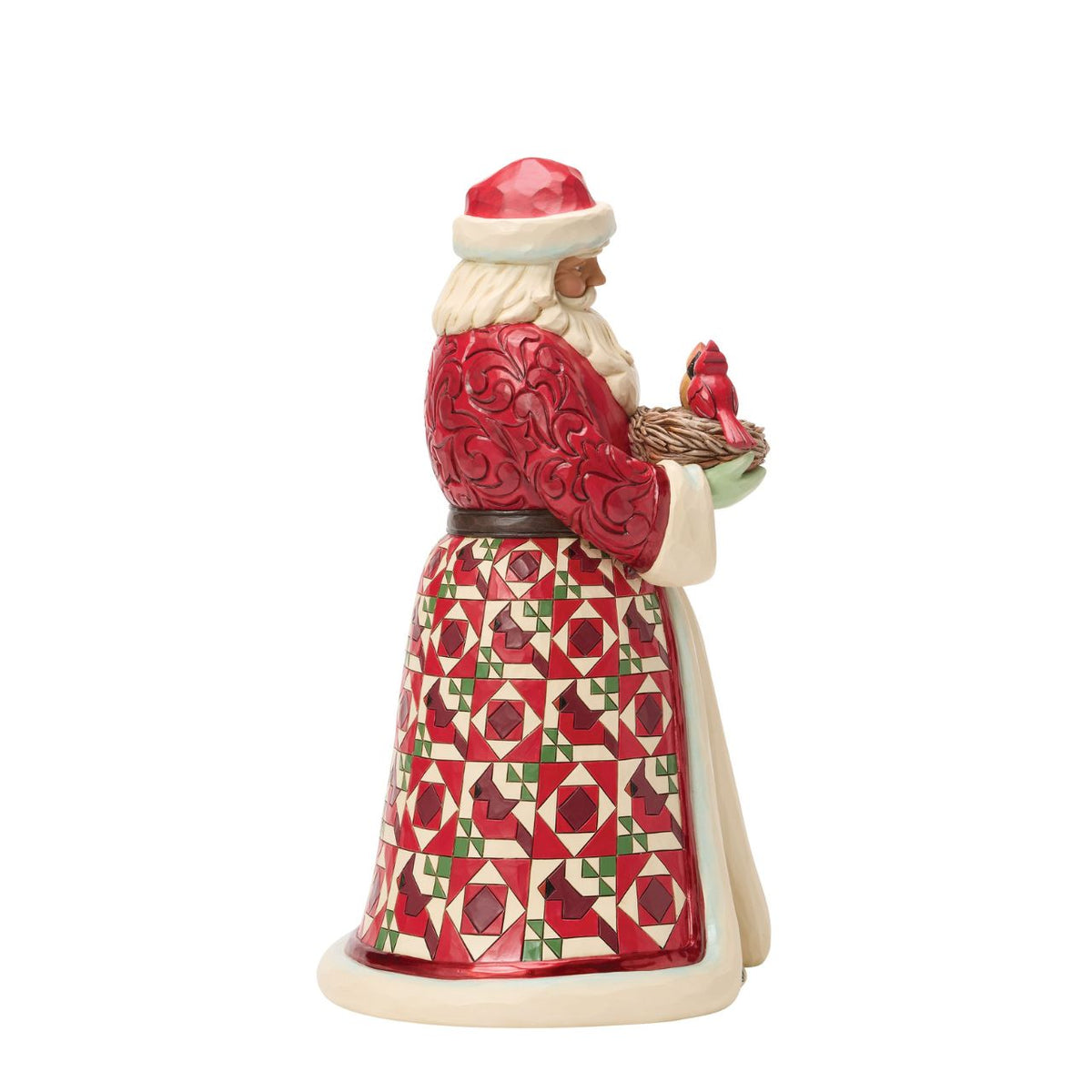 Celebrate the warmth of the season with this distinguished Collector's Edition Santa from Jim Shore's Heartwood Creek collection. Standing proudly with a nest of cardinals nestled in his arms, this beautifully crafted design reveals a charming surprise inside – delicate cardinal eggs waiting to be discovered.