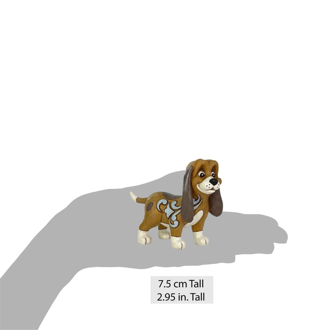 This darling Jim Shore miniature features Copper, the hound, with intricate rosemaling patterns and a heartfelt expression. He's likely on the lookout for his pal, the Fox, ready for their next adventure together in the woods.