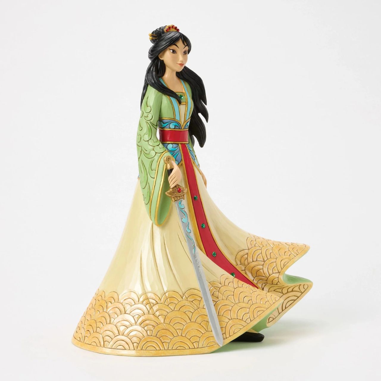 This exquisite Jim Shore deluxe princess bust showcases Mulan in her finest dress, carrying a sword with bravery and strength. With traditional makeup and cherished Chinese symbols, she captivates with beauty, legacy, and courage.