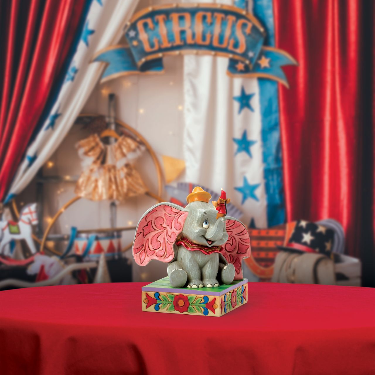 Dumbo the big eared elephant and Timothy the mouse share a joyful moment in this heartfelt Jim Shore scene.