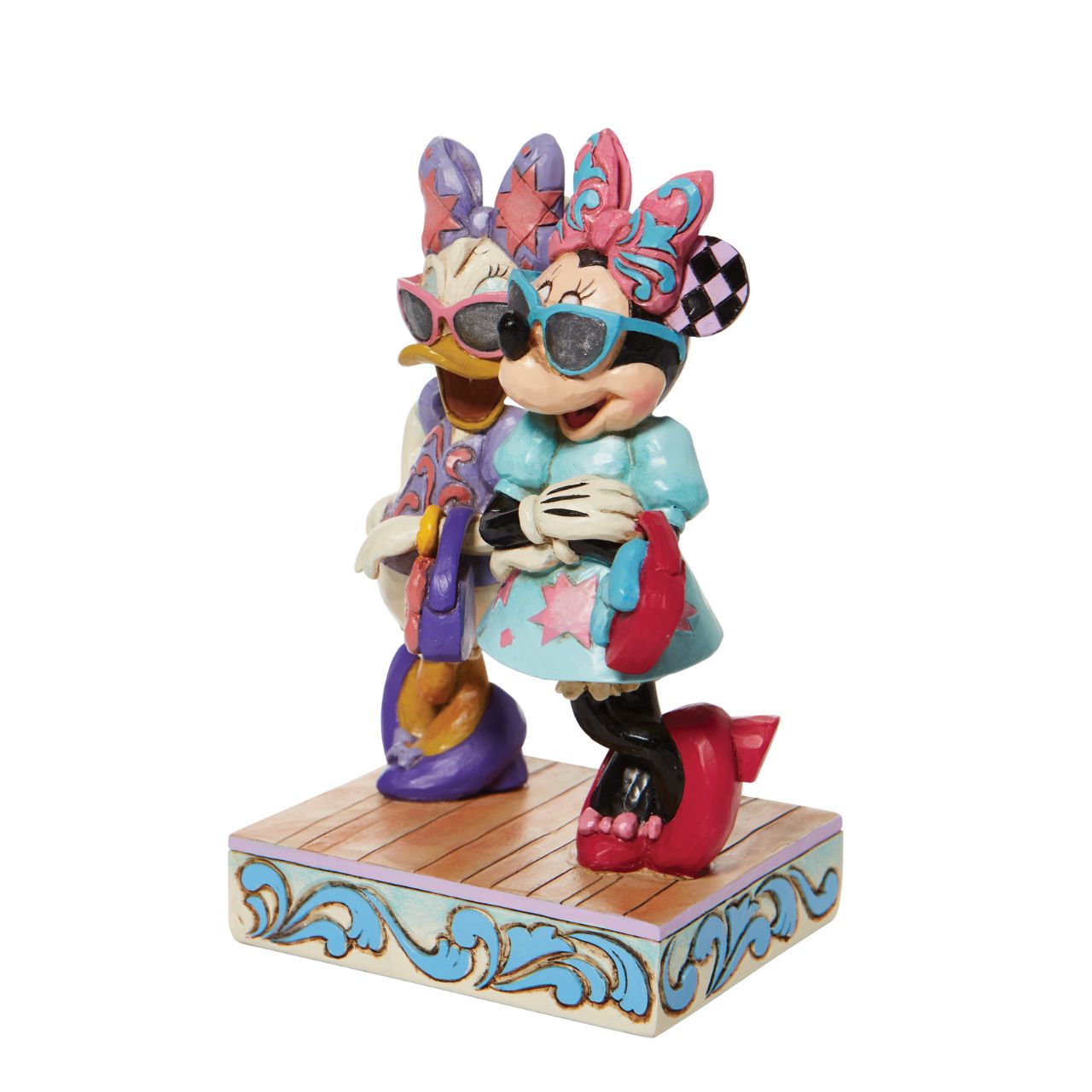 Disney "Fashionable Friends" Minnie and Daisy Figurine by Jim Shore  "Fashionable Friends" Mickey Mouse and Donald Duck would be nothing without their better and more fashionable halves! Minnie and Daisy don their finest duds to hit the town in style. Wearing shades, bows, matching purses and high heels, these ladies strike a power pose.