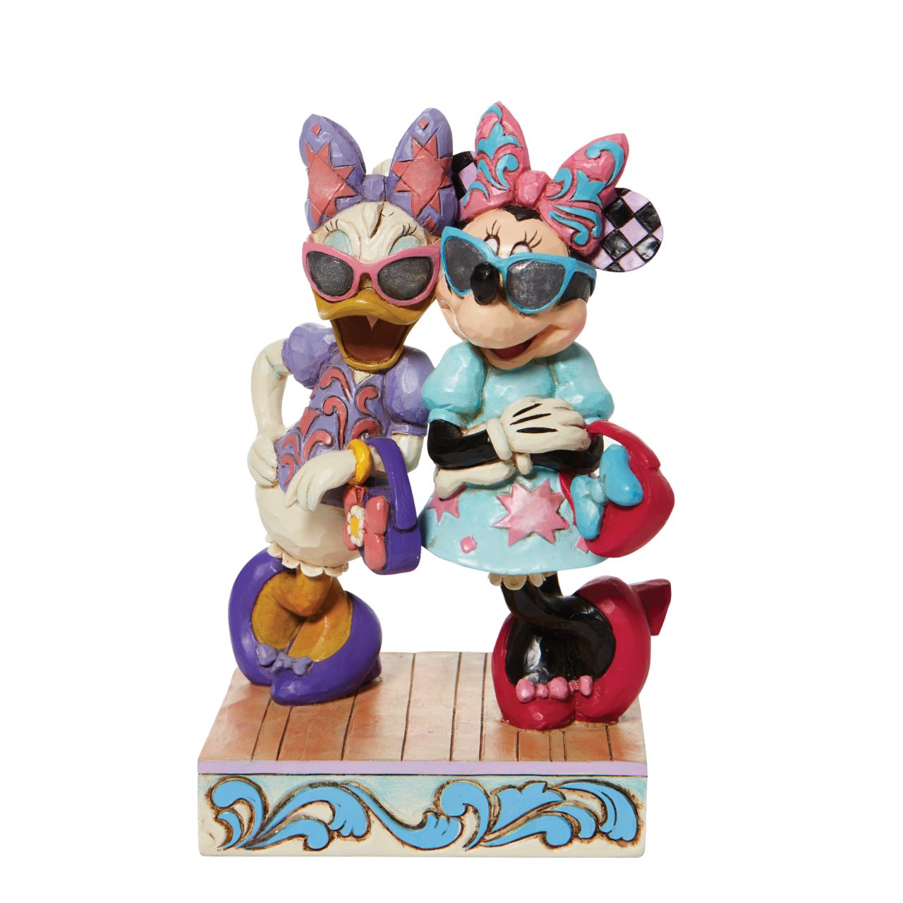 Disney "Fashionable Friends" Minnie and Daisy Figurine by Jim Shore  "Fashionable Friends" Mickey Mouse and Donald Duck would be nothing without their better and more fashionable halves! Minnie and Daisy don their finest duds to hit the town in style. Wearing shades, bows, matching purses and high heels, these ladies strike a power pose.