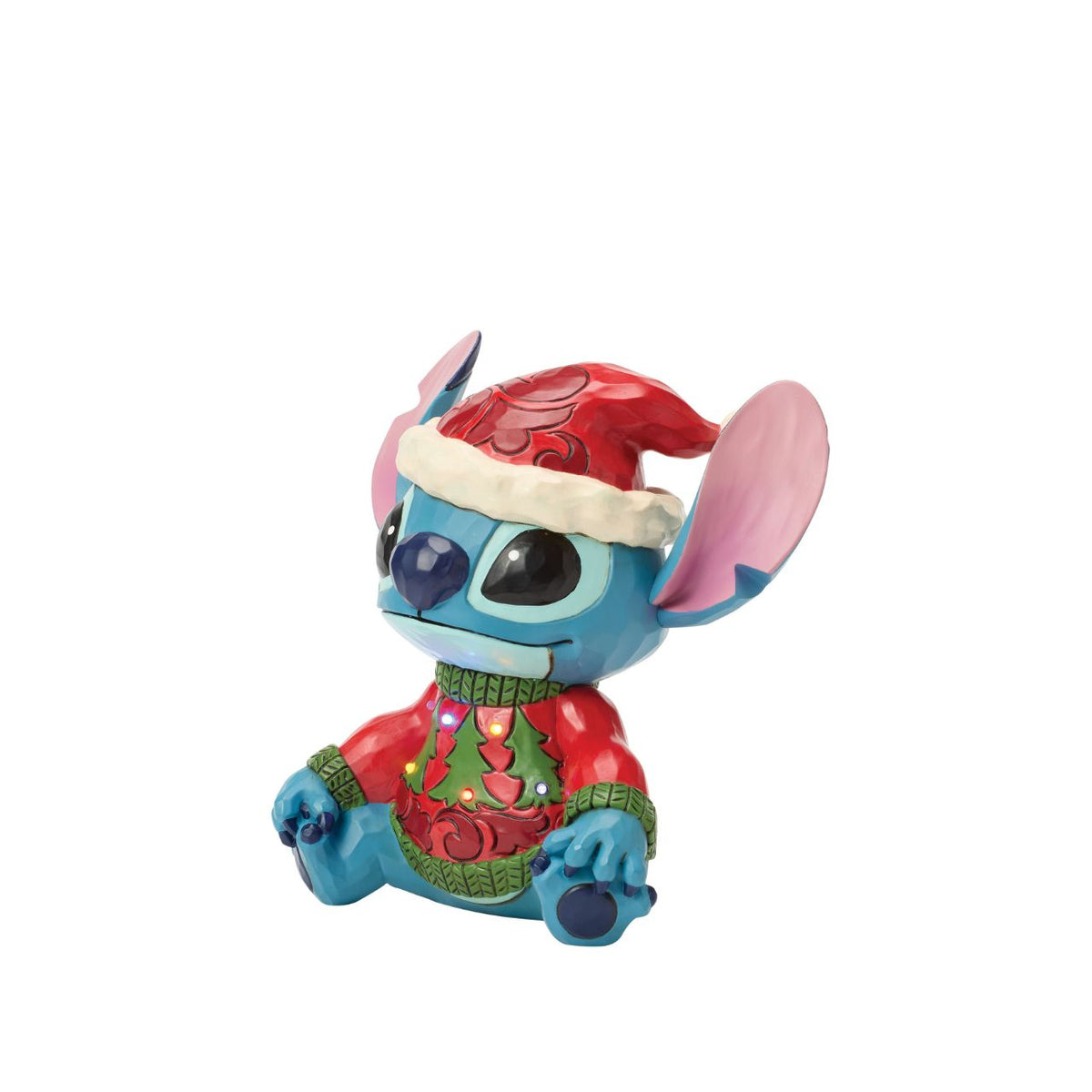 Stitch brings holiday humour to life in this glowing Jim Shore bust with an LED lit Christmas sweater. Wearing his sweater and Santa hat with a smile, the mischievous alien proves holiday magic spans across the universe with festive folk art style.