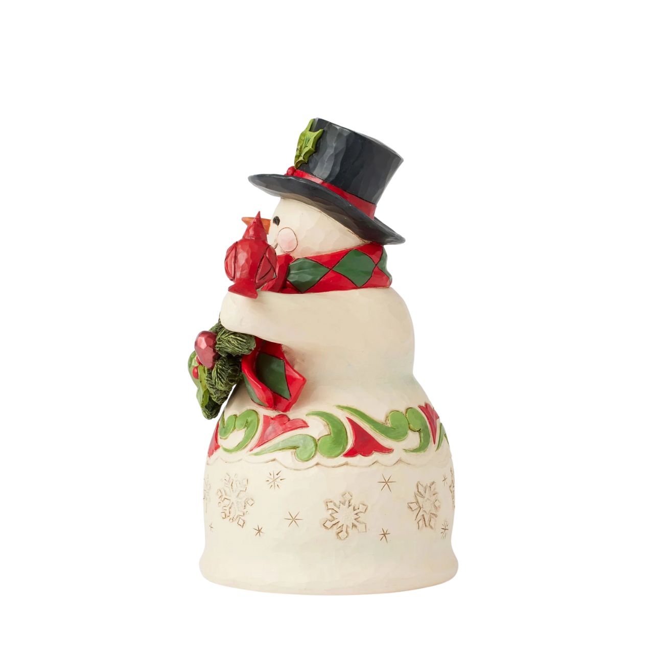 This charming snowman wears intricate snowflakes and Jim Shore's iconic rosemaling designs, spreading festive cheer while holding garland and a cardinal. Wearing a holly-trimmed top hat and a smile, he makes the season brighter.