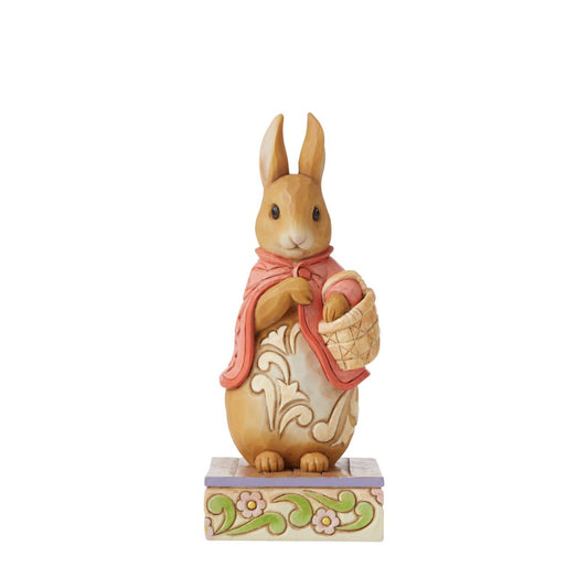 Beatrix Potter Flopsy Good Little Bunny Figurine  Award winning folk artist Jim Shore brings his unique style to Beatrix Potter's beloved story, The Tale of Peter Rabbit, through charming hand-crafted gifts that will delight her readers of all ages. This Jim Shore figurine features the ever-so-sweet Flopsy, standing gracefully in her famous pink cape. 