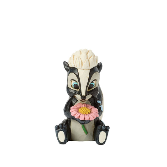 This darling Jim Shore miniature features Flower, the skunk from Bambi, adorned with striking rosemaling and holding a handful of fresh flowers. With a bright smile and childlike love, she radiates sweetness and charm.