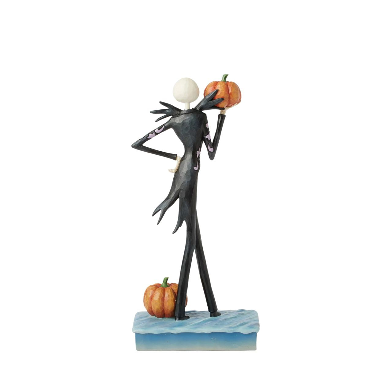 In this captivating Jim Shore design, Jack Skellington, clad in a striking black and white suit, exudes charm with a mischievous grin as he holds a Jack-o-lantern. Bring home Jim's newest The Nightmare Before Christmas designs.