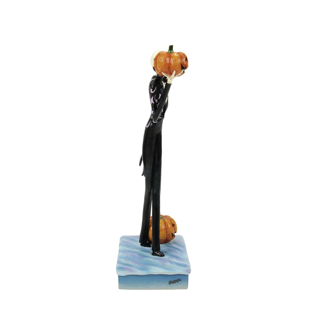 In this captivating Jim Shore design, Jack Skellington, clad in a striking black and white suit, exudes charm with a mischievous grin as he holds a Jack-o-lantern. Bring home Jim's newest The Nightmare Before Christmas designs.