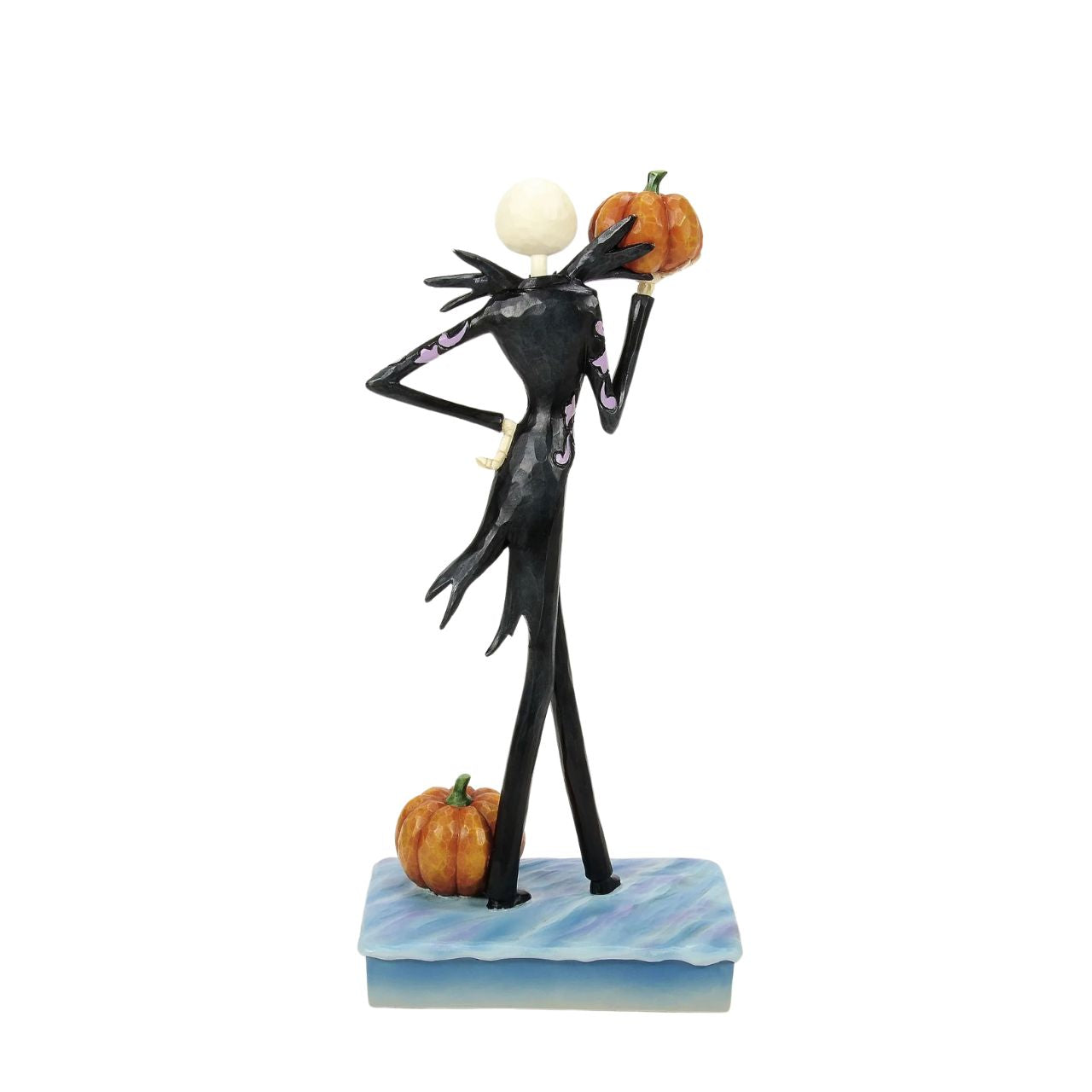 In this captivating Jim Shore design, Jack Skellington, clad in a striking black and white suit, exudes charm with a mischievous grin as he holds a Jack-o-lantern. Bring home Jim's newest The Nightmare Before Christmas designs.