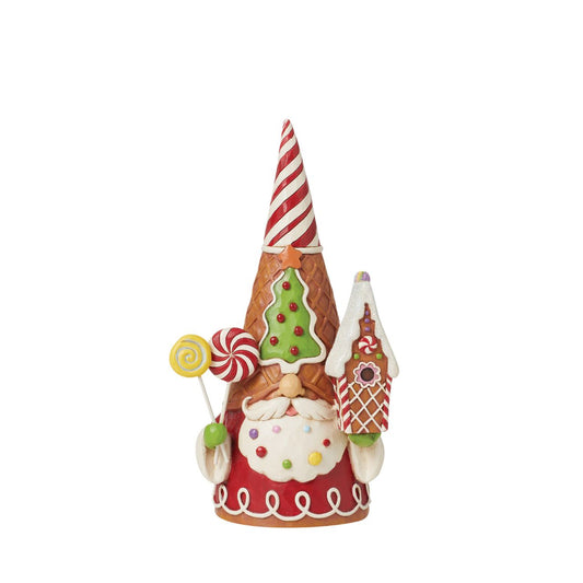 Add some candy to your Christmas with this festive gingerbread gnome from Jim Shore! Wearing a waffle cone hat, he holds peppermint lollipops and a gingerbread house. With sprinkles in his beard, he celebrates the sweetness of the season.