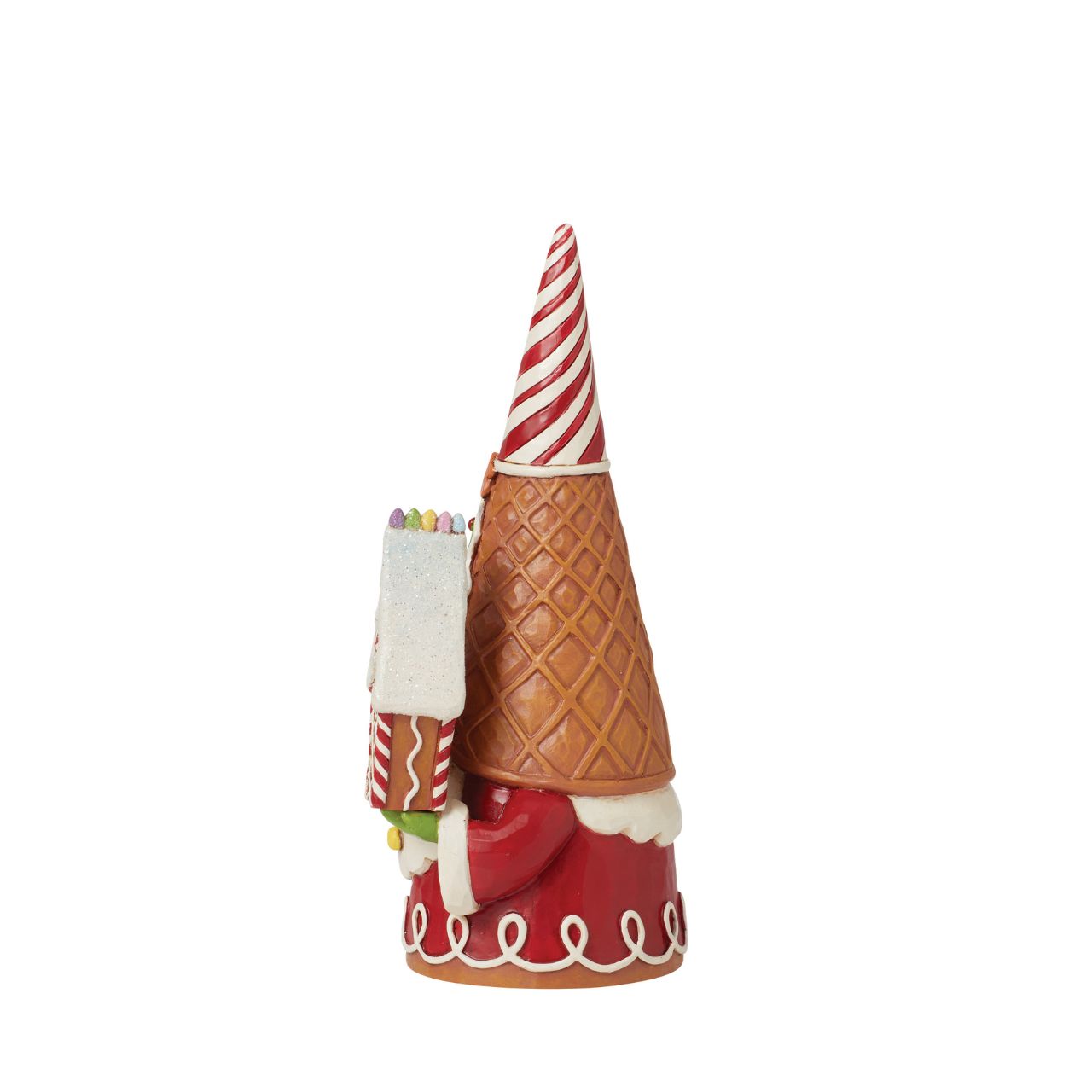 Add some candy to your Christmas with this festive gingerbread gnome from Jim Shore! Wearing a waffle cone hat, he holds peppermint lollipops and a gingerbread house. With sprinkles in his beard, he celebrates the sweetness of the season.