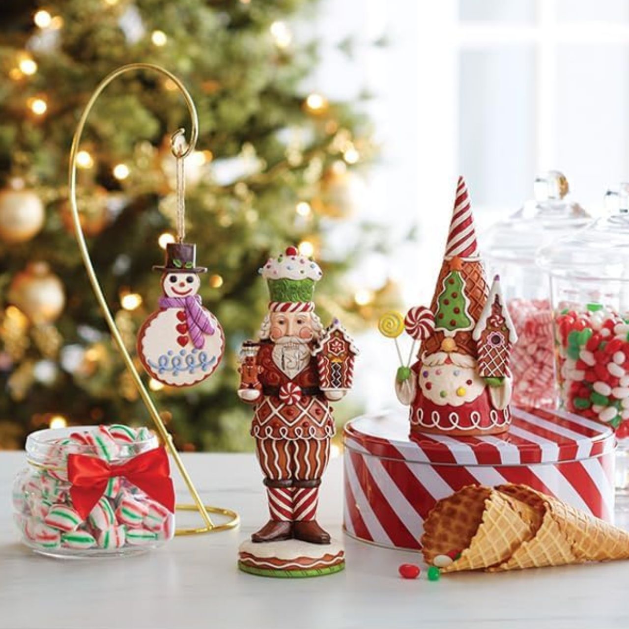 Add some candy to your Christmas with this festive gingerbread gnome from Jim Shore! Wearing a waffle cone hat, he holds peppermint lollipops and a gingerbread house. With sprinkles in his beard, he celebrates the sweetness of the season.