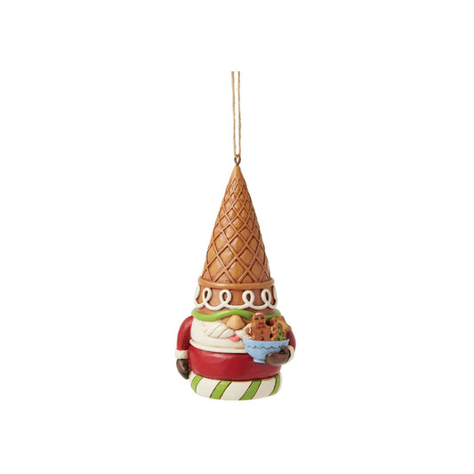 This whimsical Jim Shore Gingerbread Christmas ornament presents a charming gingerbread gnome, adorned with red and green icing and sprinkles, wearing an ice cream cone as a hat. Holding a bowl of candy, he'll bring a sweet and festive spirit to your holiday.