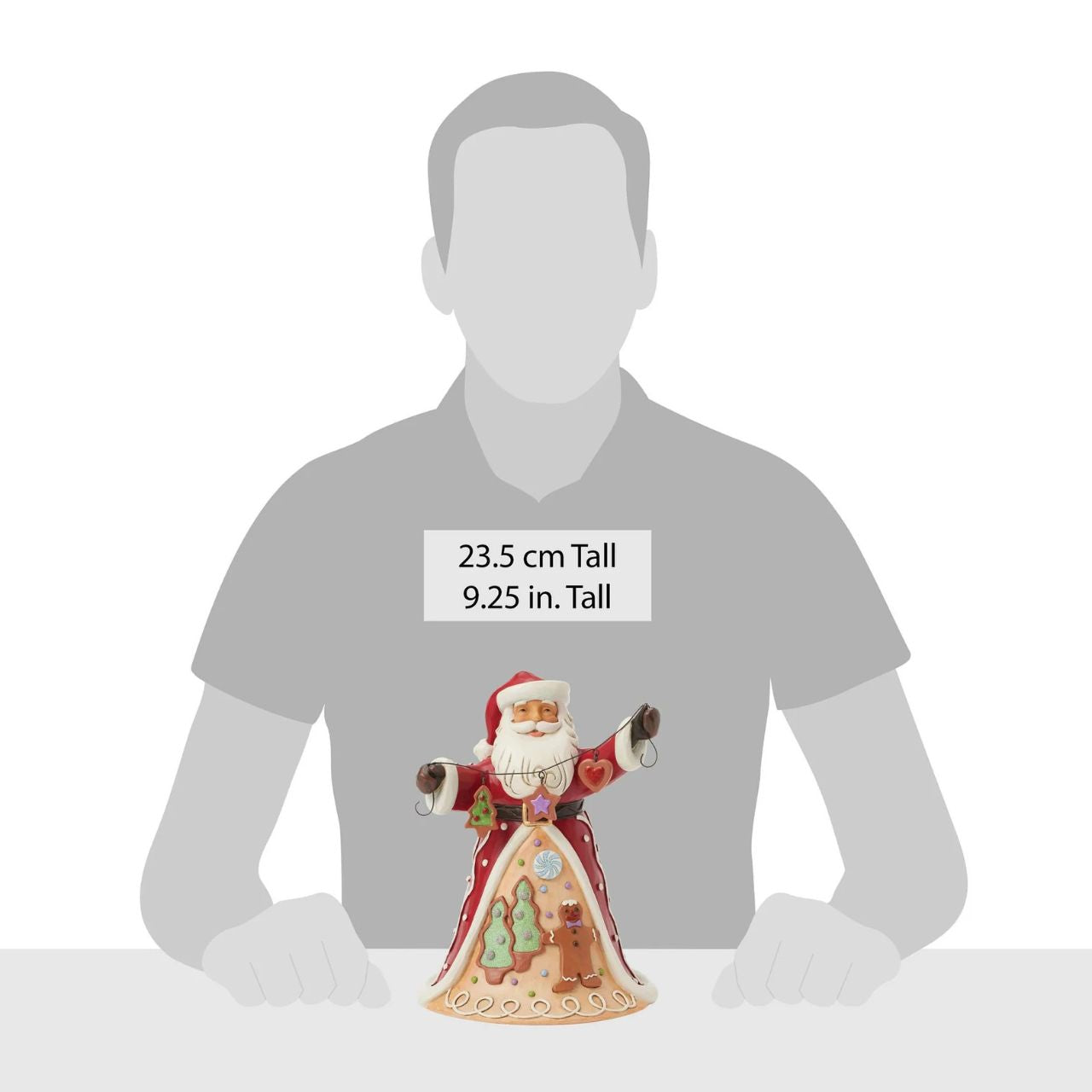 Santa brings the Gingerbread Christmas holiday spirit in this Jim Shore design, holding a string of decorated Christmas cookies. What a joyful smile, Santa presents with his festive garland, while his cloak features a scene of colourful cookies with icing decorations.