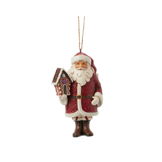 This stunning Gingerbread Christmas Jim Shore ornament features Santa holding a beautifully crafted gingerbread house and a candy cane, all while draped in an ornate rosemaling cloak. With intricate details and vibrant colours, this Santa captures the holiday spirit.