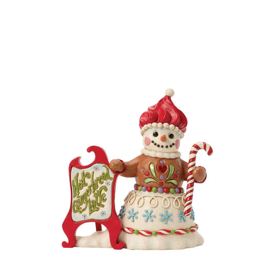 This sweet snowman holds a festive sign, inviting all to join in the holiday fun. Jim Shore's signature folk-art designs blend with candy-inspired accents, making it look almost good enough to eat.