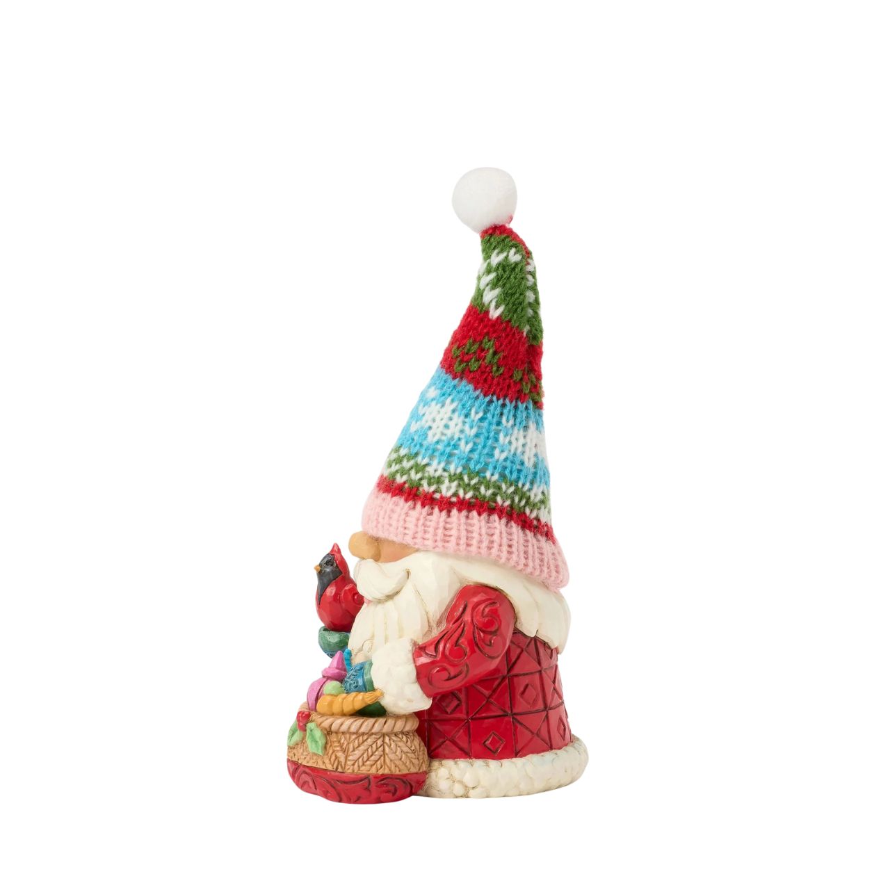 This festive Jim Shore gnome dons a knit holiday hat patterned with snowflakes and Christmas colours, bringing a cosy, inviting texture. Carrying a bag full of ornaments and gently holding a cardinal, he brings holiday cheer to your home.