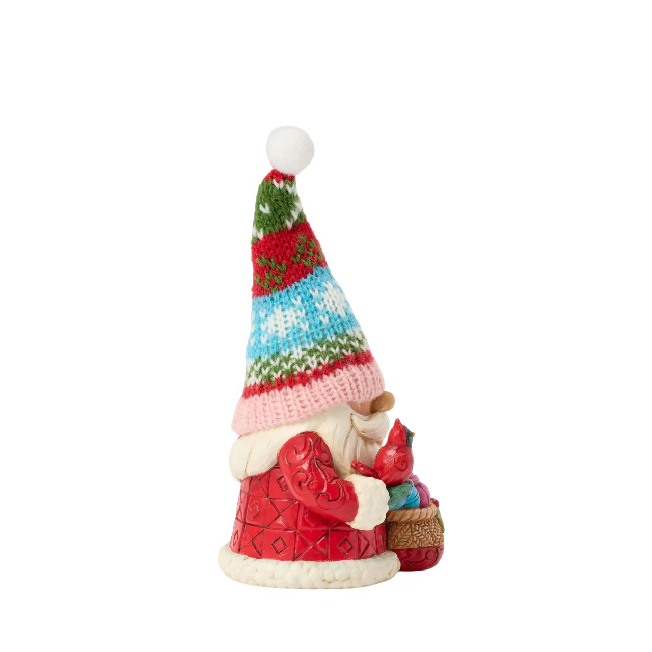This festive Jim Shore gnome dons a knit holiday hat patterned with snowflakes and Christmas colours, bringing a cosy, inviting texture. Carrying a bag full of ornaments and gently holding a cardinal, he brings holiday cheer to your home.