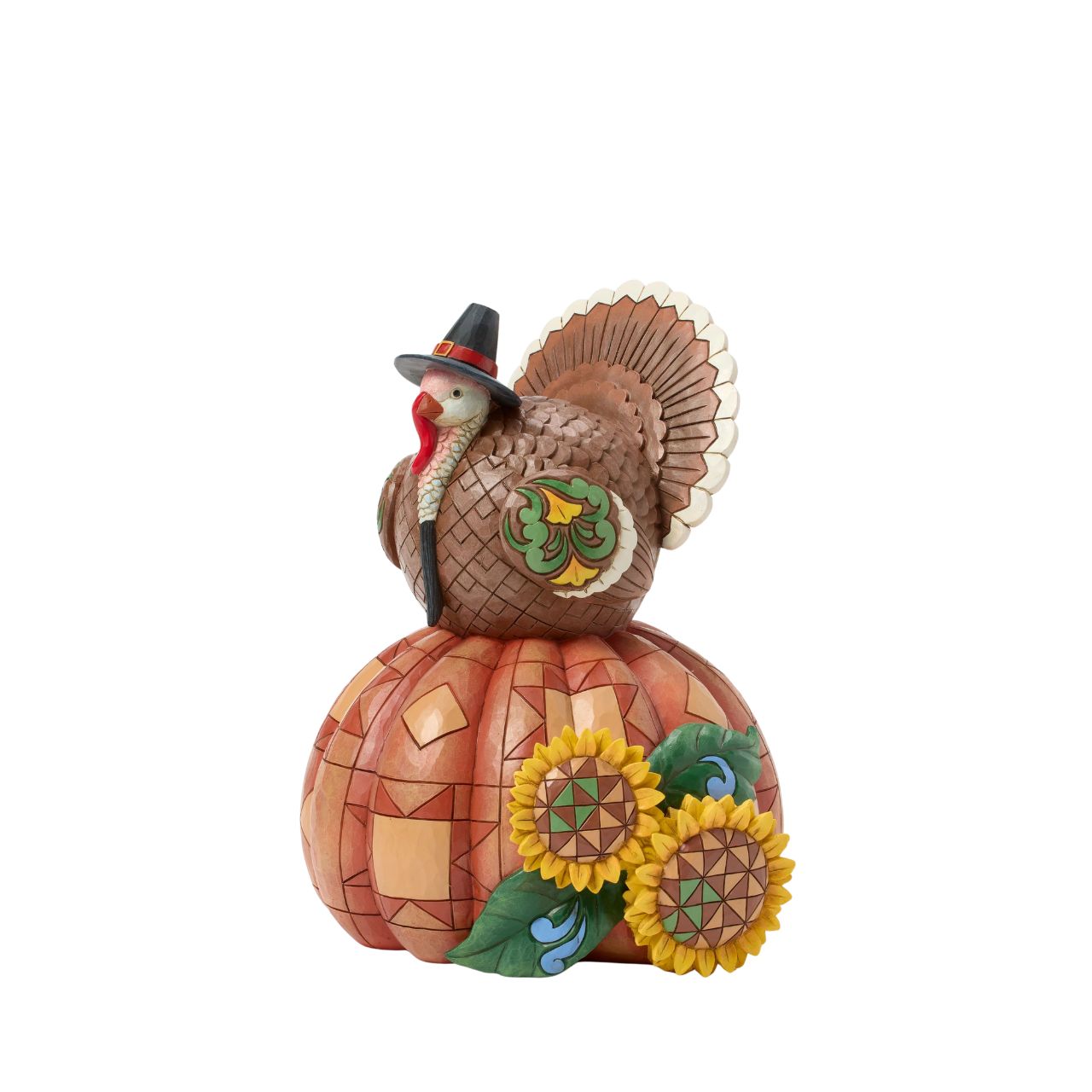 Celebrate fall with this delightful Jim Shore figurine of a turkey perched atop a pumpkin, both are adorned with intricate patchwork patterning and rosemaling flowers. The Harvest turkey brings autumn's bounty to your home.