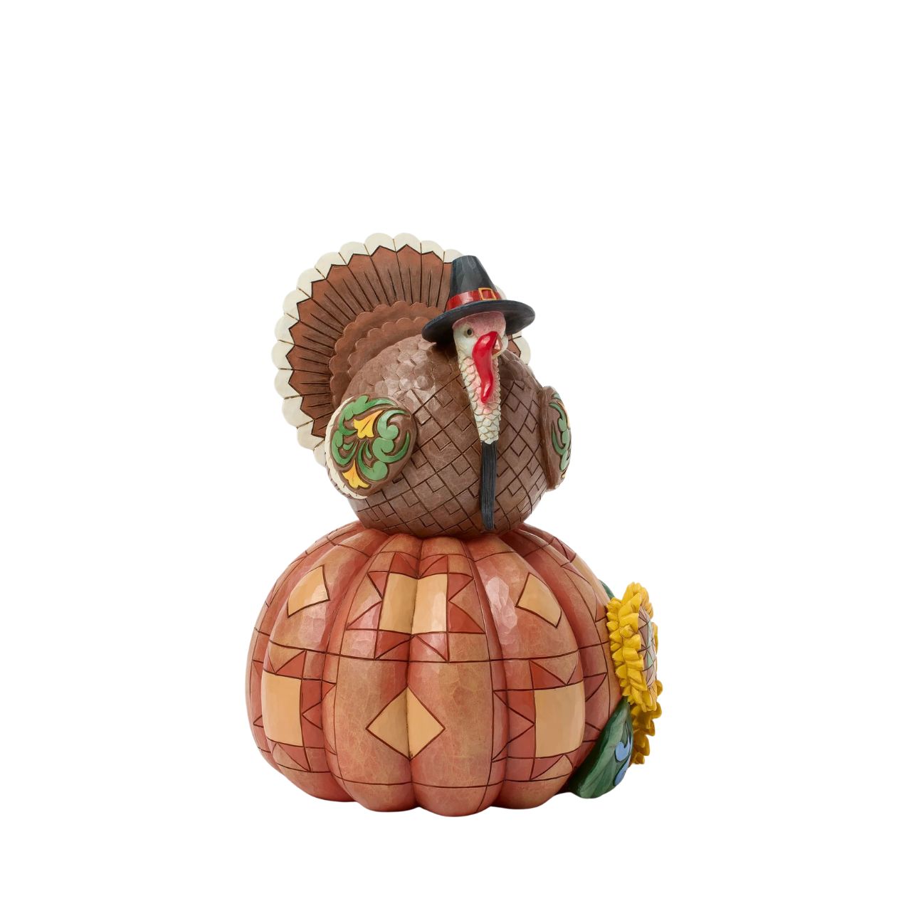 Celebrate fall with this delightful Jim Shore figurine of a turkey perched atop a pumpkin, both are adorned with intricate patchwork patterning and rosemaling flowers. The Harvest turkey brings autumn's bounty to your home.