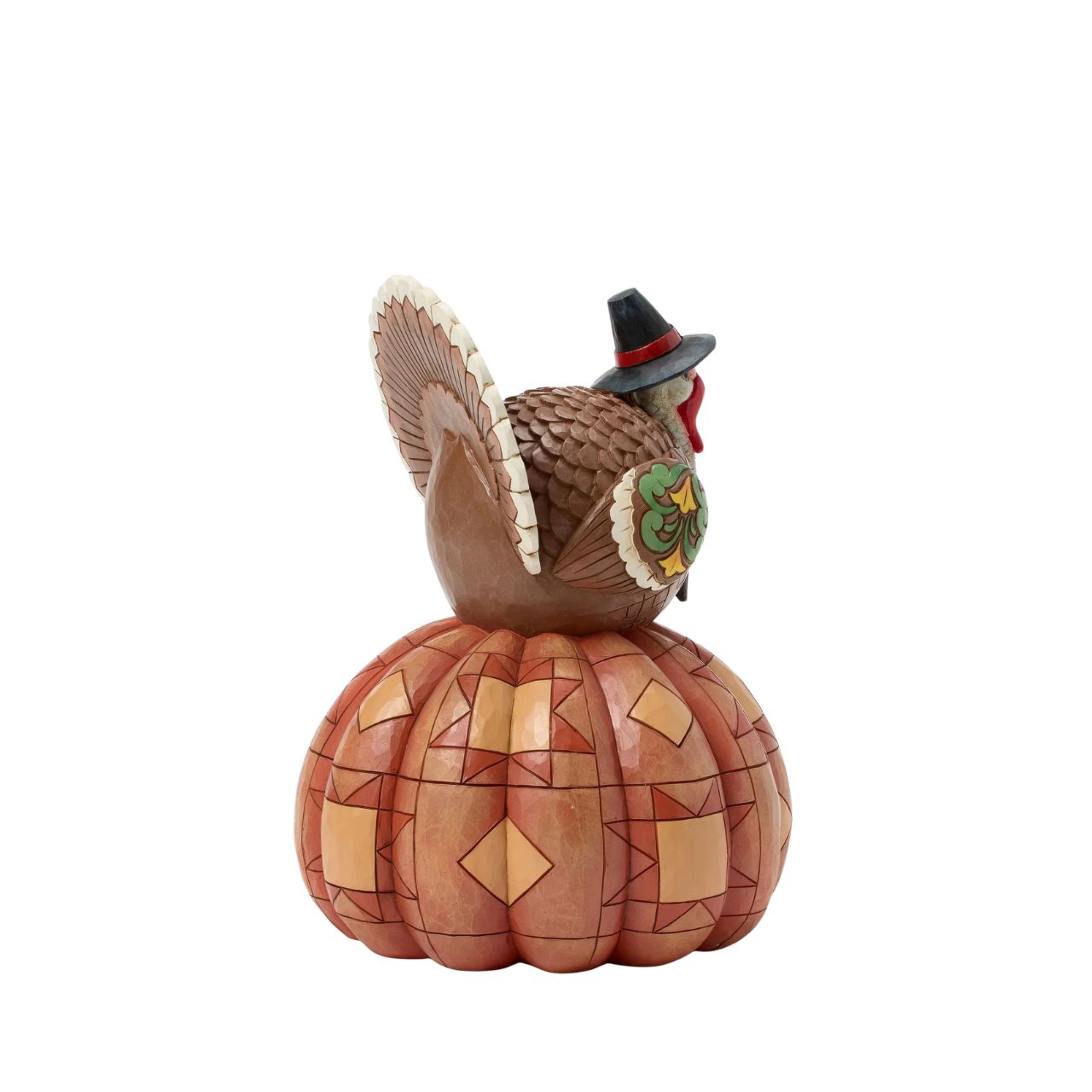 Celebrate fall with this delightful Jim Shore figurine of a turkey perched atop a pumpkin, both are adorned with intricate patchwork patterning and rosemaling flowers. The Harvest turkey brings autumn's bounty to your home.
