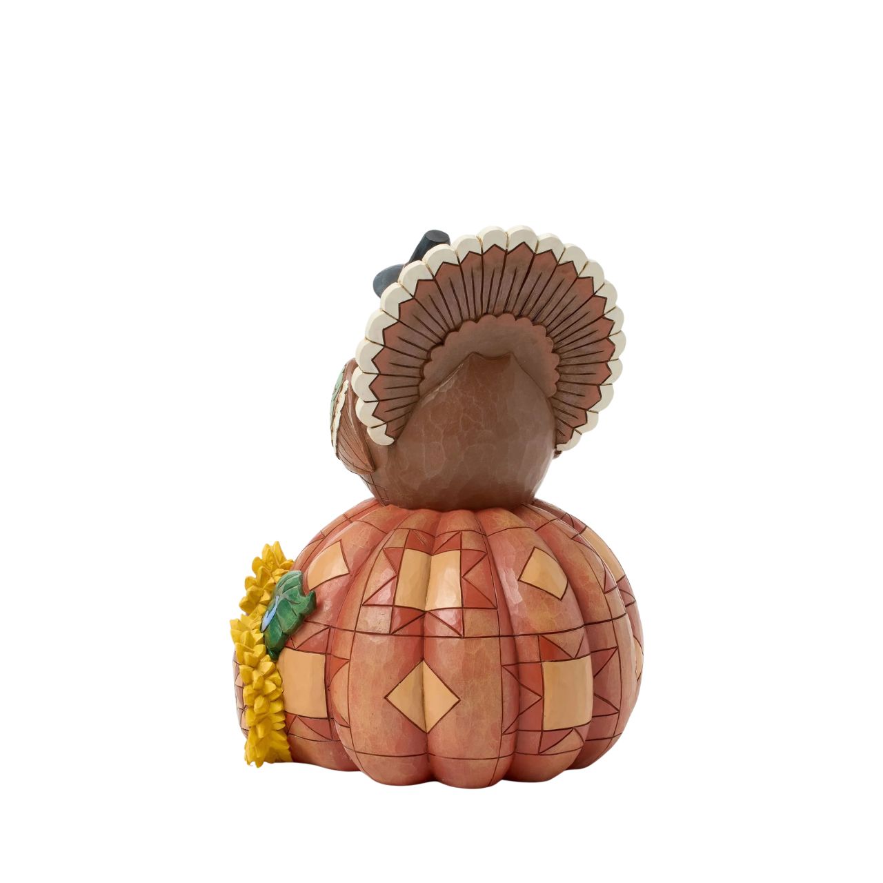 Celebrate fall with this delightful Jim Shore figurine of a turkey perched atop a pumpkin, both are adorned with intricate patchwork patterning and rosemaling flowers. The Harvest turkey brings autumn's bounty to your home.