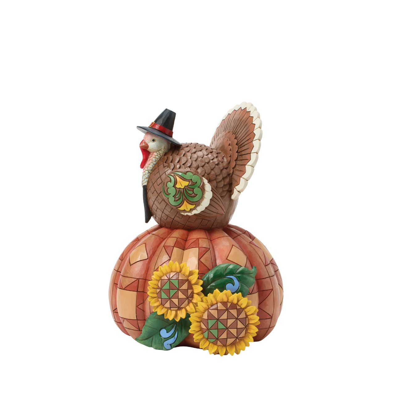Celebrate fall with this delightful Jim Shore figurine of a turkey perched atop a pumpkin, both are adorned with intricate patchwork patterning and rosemaling flowers. The Harvest turkey brings autumn's bounty to your home.
