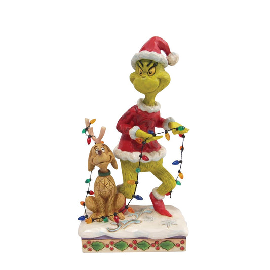 Grinch and Max Tiptoeing Wrapped in Lights Figurine  Sneaking across Whoville on Christmas Eve, The Grinch and Max manoeuvre through decorations and lights to unsuspecting chimneys all across town. On a mission to steal Christmas, the conspiring Grinch wears a mischievous grin as he trips around lights in this delightful Jim Shore collectable.