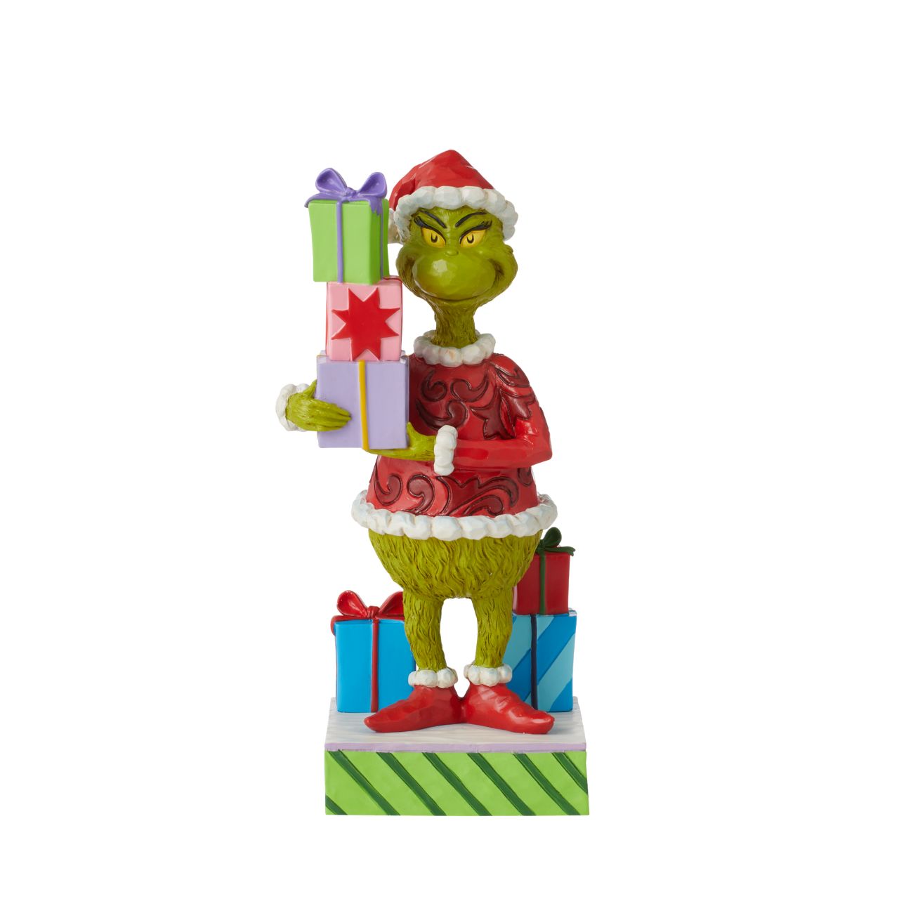 Grinch Holding Presents Figurine  Is the Grinch stealing presents again or has his heart changed to a kinder shape? You decide The Grinch's intentions when placing this colourful Jim Shore design in your home. Whatever his motive, The Grinch is giddy to be apart of your holiday.