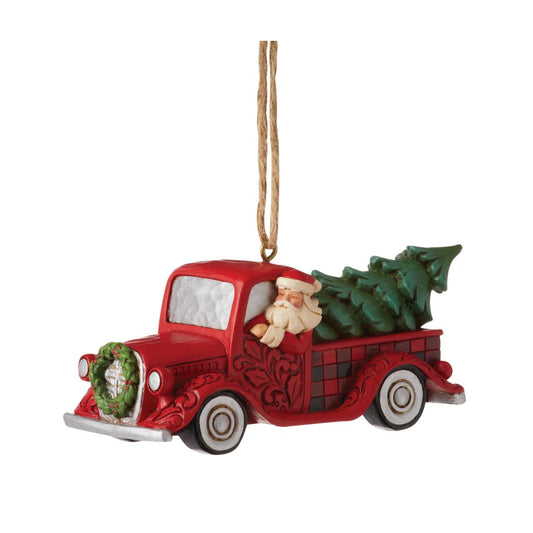 Heartwood Creek  Highland Glen Santa in a Red Truck Hanging Ornament  Designed by award winning artist Jim Shore as part of the Heartwood Creek Highland Glen Collection, hand crafted using high quality cast stone and hand painted. this festive Red Truck Hanging Ornament is perfect for the Christmas season.