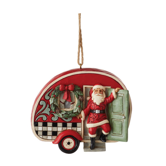 Heartwood Creek Highland Glen Santa with Camper Hanging Ornament  Designed by award winning artist Jim Shore as part of the Heartwood Creek Highland Glen Collection, hand crafted using high quality cast stone and hand painted, this Santa in a Camper hanging ornament is perfect for the Christmas season.