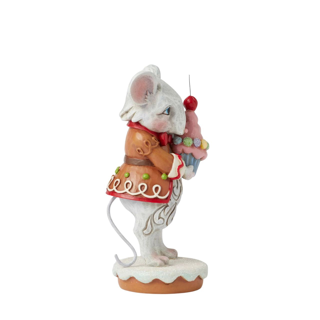 This charming Gingerbread Christmas mouse by Jim Shore offers you a delightful cupcake topped with a bright red cherry. Dressed in a festive gingerbread coat adorned with icing details, his sweet smile and cheerful spirit, brings a touch of whimsy to you.