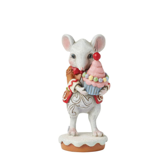 This charming Gingerbread Christmas mouse by Jim Shore offers you a delightful cupcake topped with a bright red cherry. Dressed in a festive gingerbread coat adorned with icing details, his sweet smile and cheerful spirit, brings a touch of whimsy to you.