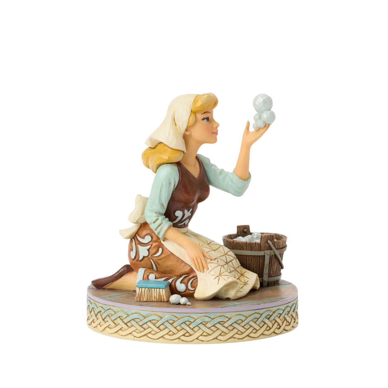 Cinderella's spirit remains unbroken in this inspiring Jim Shore scene. Dressed as a maid, she finds joy in her work, catching a bubble as she scrubs the floors. Jim Shore's enchanting details capture her beauty and resilience.