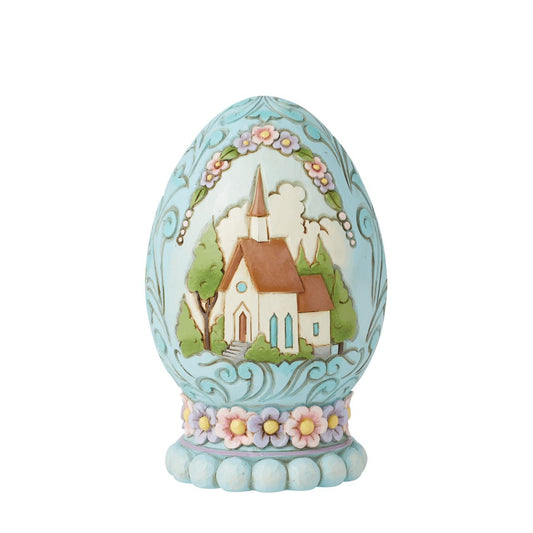 This beautiful 3D diorama egg depicts a quaint and tranquil church scene, hand painted in soft spring colours. Perfect for those who want a different kind of Easter display. Comes in fully branded packaging.