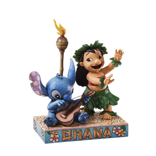 Disney Lilo and Stitch Figurine by Jim Shore  Inspired by the ending sequence of Disney's Lilo and Stitch, Jim Shore creates a beautiful memento to Ohana or Family. Stitch picks at his hawaiin guitar while lilo dances her native luau.