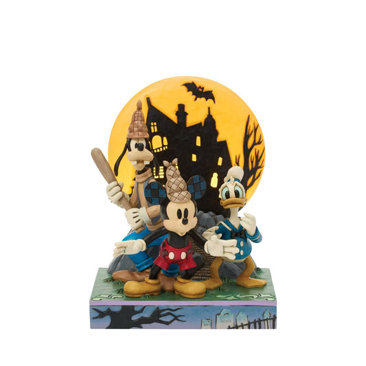 Disney's Mickey, Goofy, and Donald appear with scared expressions in this spooky Jim Shore design. Goofy holds a bat while an LED moon glows behind them, adding eerie charm and detailed folk-art flair to their ghostly adventure.
